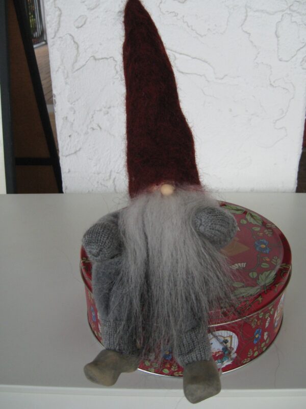 Sitting Vättetomte with red hat and sheepsking vest, movable arms and legs, wooden clogs, 14" tall, handmade by "Gnesta Tomten", Sweden