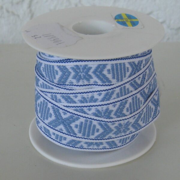 White ribbon with light blue pattern sold by yard