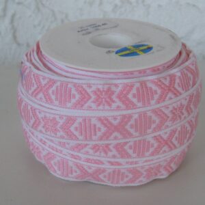White ribbon with pale pink pattern sold by yard