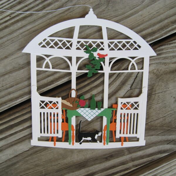 "Gazebo" papercut w/cat and picnic  Made in Denmark by Oda Wiedbrecht 6.5" x 6.5"