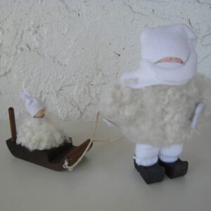 white sheepskin tomte w/ child on sled  6" tall 7" long  Made in Sweden