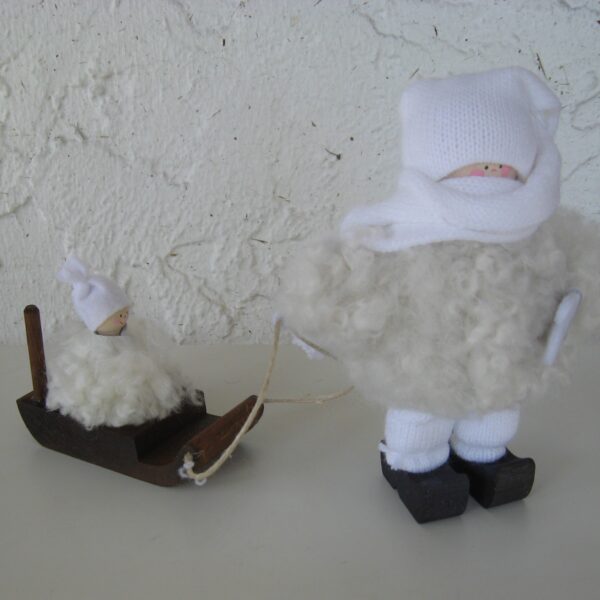 white sheepskin tomte w/ child on sled  6" tall 7" long  Made in Sweden